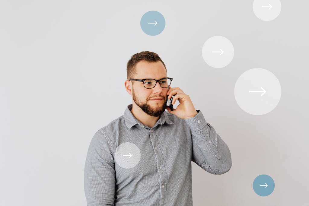 Professional man talking on smartphone with overlay arrow graphics, symbolizing communication.