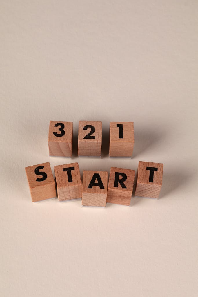 Wooden blocks arranged to spell out 3 2 1 Start on a neutral background.
